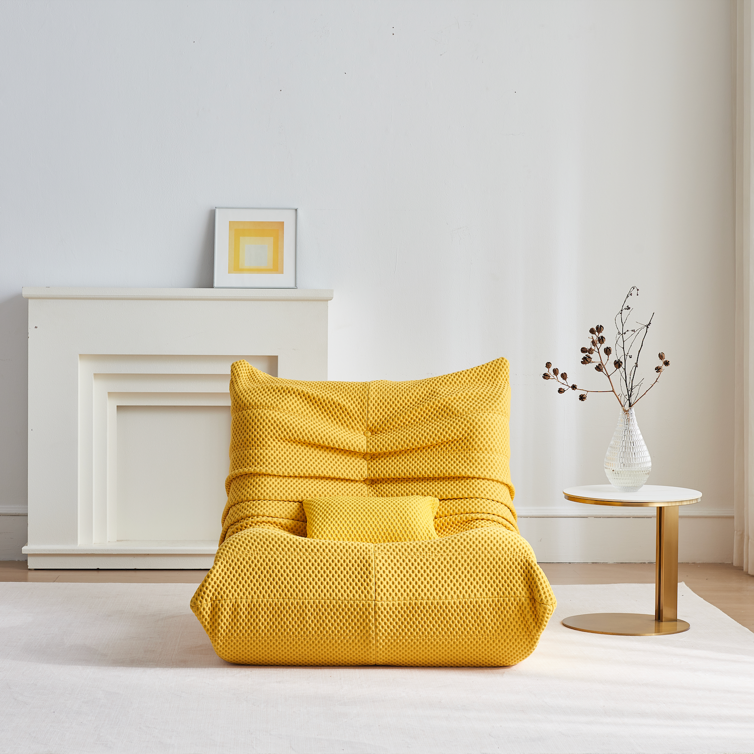 Zoovee's Yellow airpore bean bag chair in a minimalistic room with a white wall and small table.