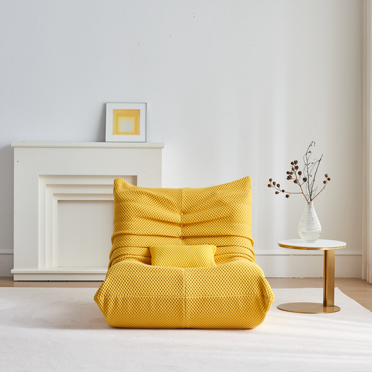 Zoovee's Yellow airpore bean bag chair in a minimalistic room with a white wall and small table.