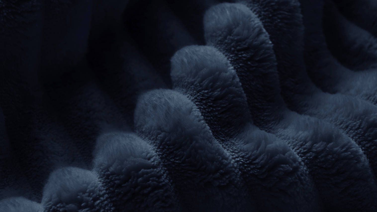 Close-up of Zoovee's dark navy blue textured corduroy fabric with a raised, wavy, looped pattern.