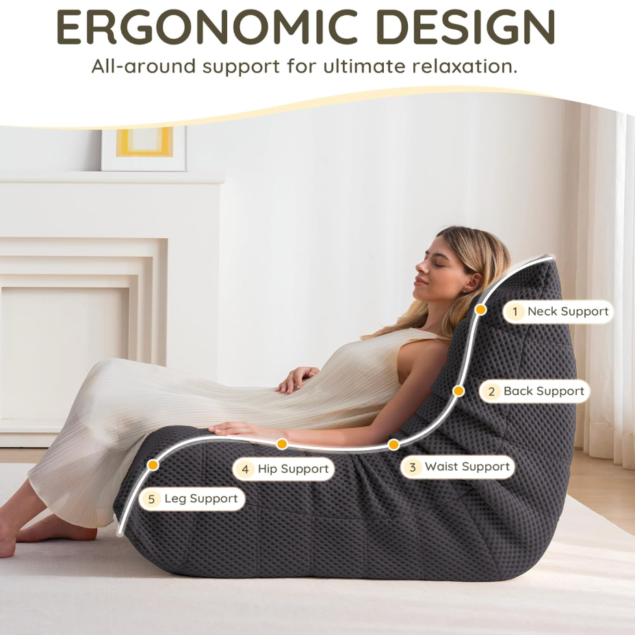 Woman using an ergonomic bean bag chair with labeled support points in a bedroom setting.