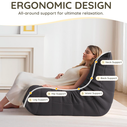 Woman using an ergonomic bean bag chair with labeled support points in a bedroom setting.