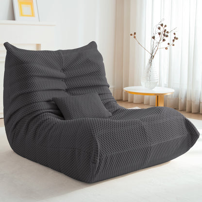 Zoovee's Gray airpore bean bag chair in a room with a table and curtains.