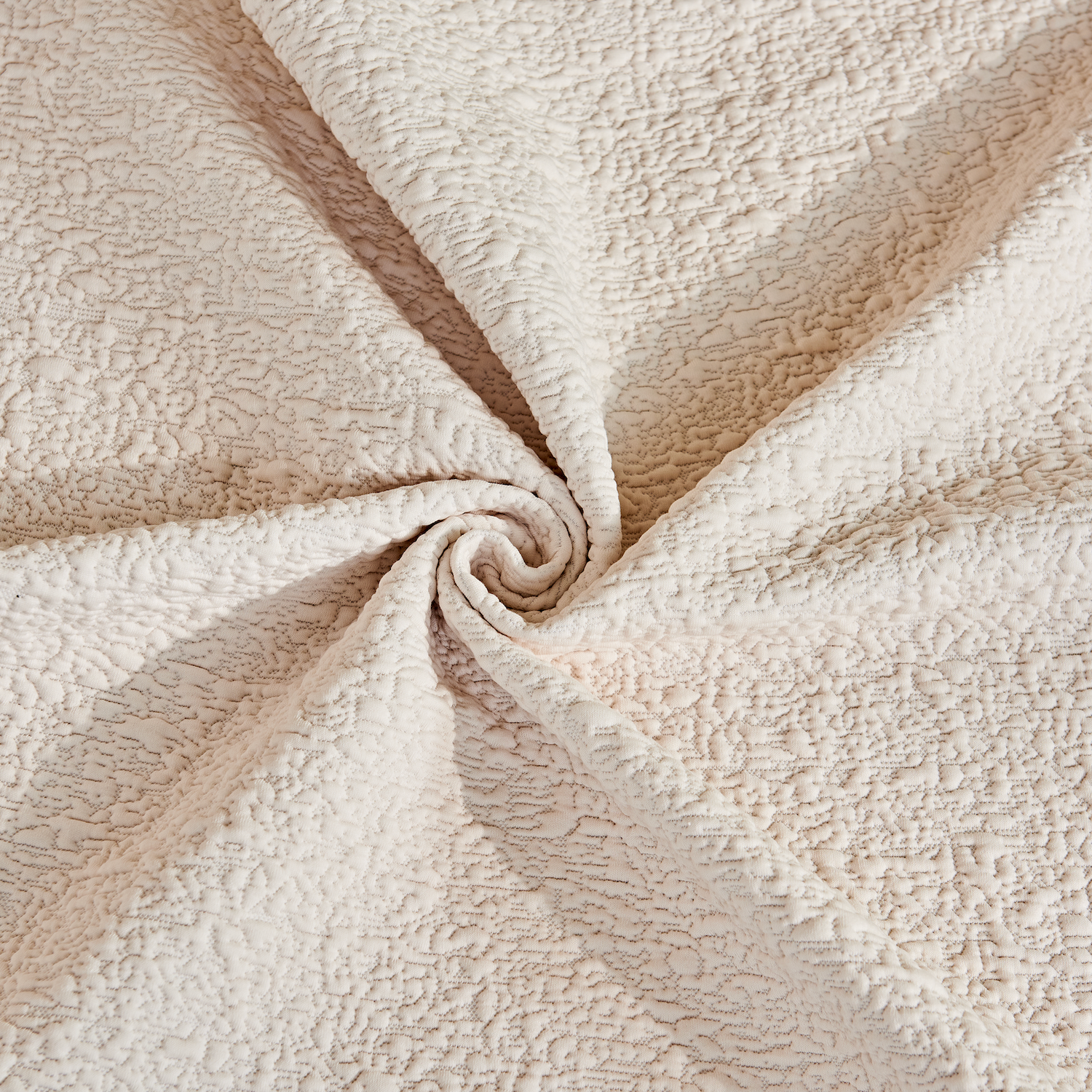 Close-up of beige fleece fabric with a swirl pattern