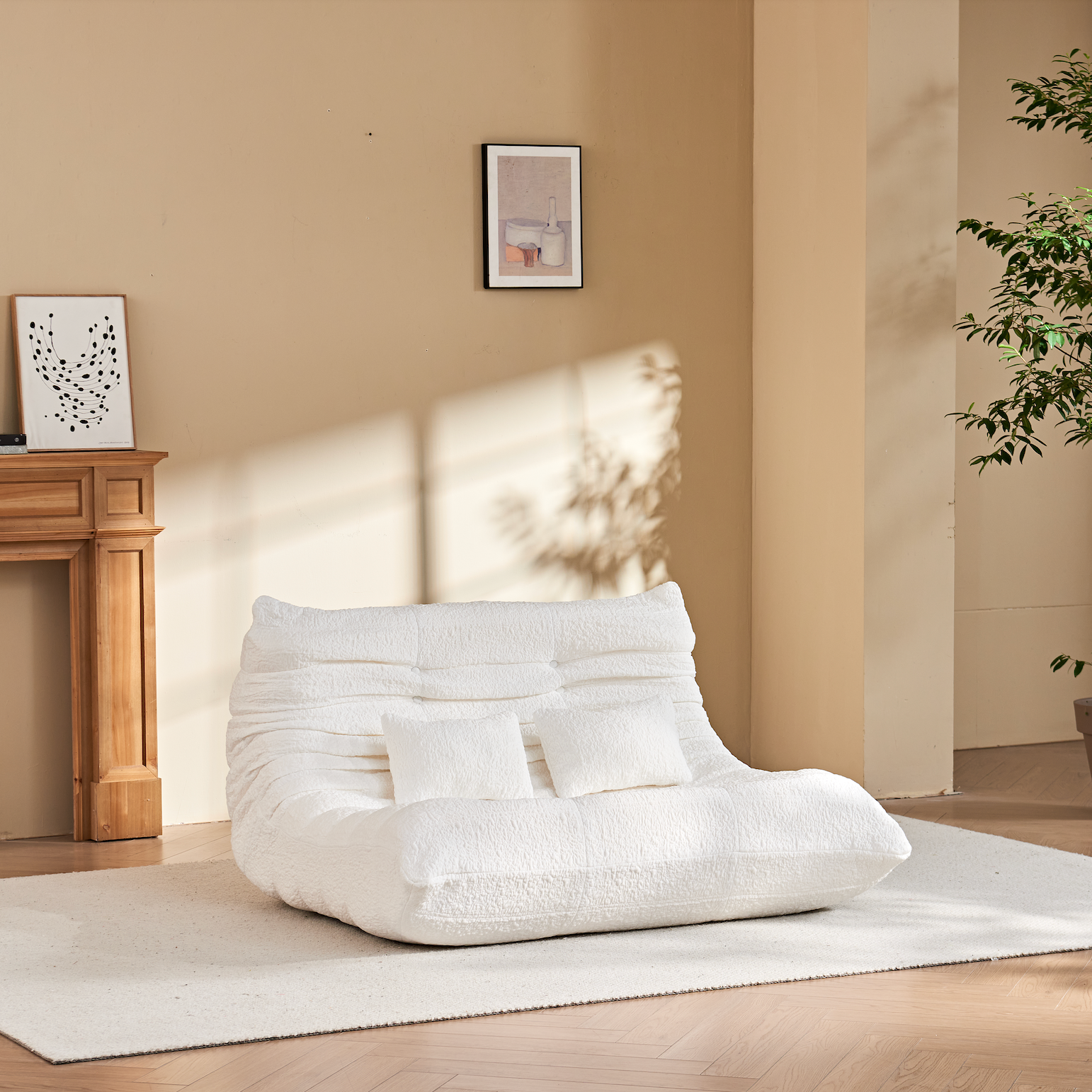 Zoovee's White Chenille bean bag chair loveseat in a room with a fireplace, plant, and framed pictures.