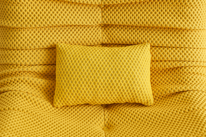 Yellow airpore fabric textured pillow on a matching yellow bean bag chair