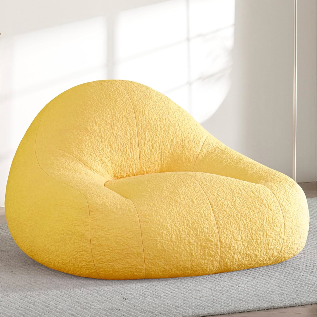 Zoovee's oversized Yellow chenille bean bag chair in a room with a neutral color scheme
