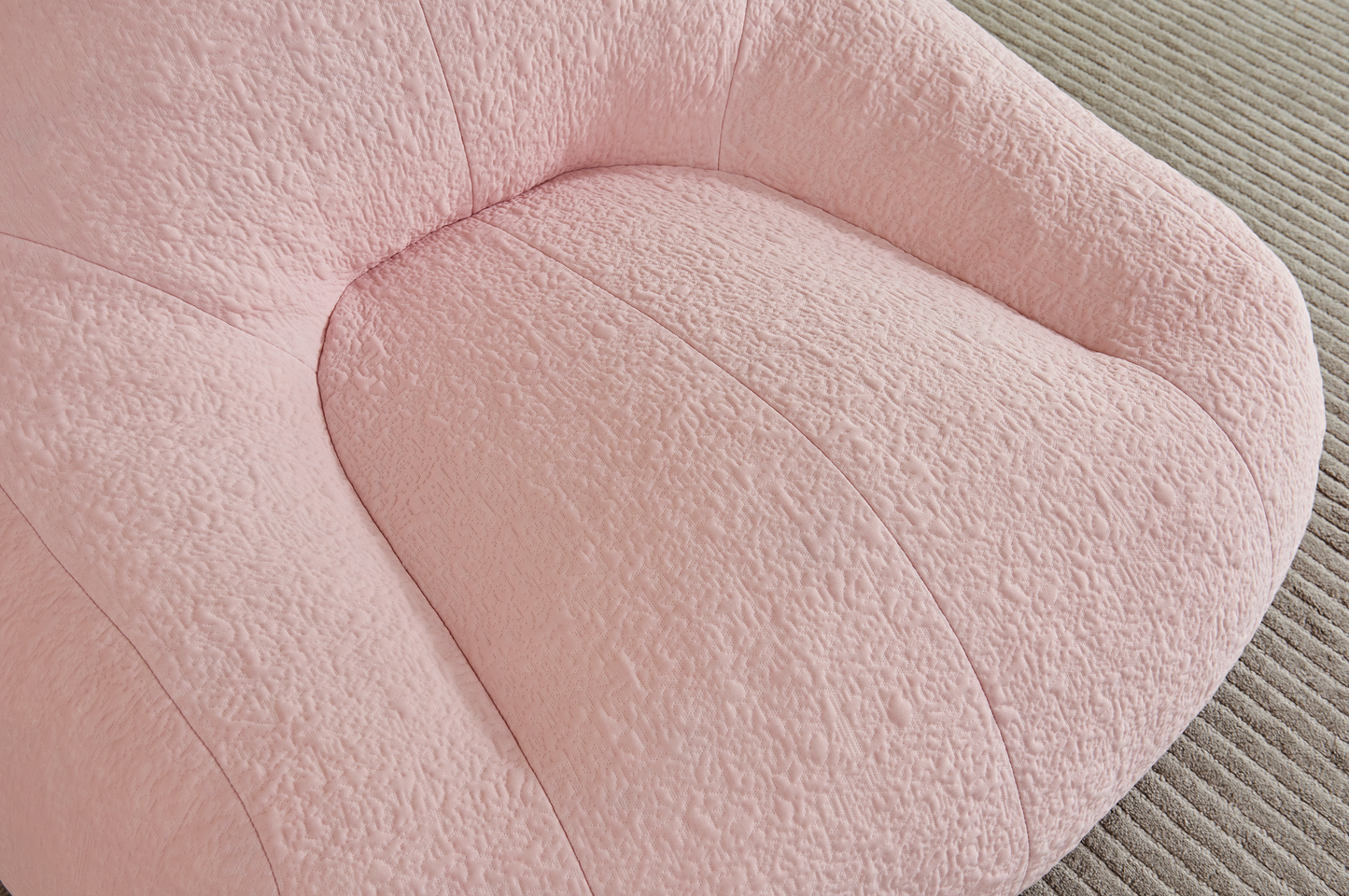Close-up of a textured pink bean bag chair on a carpet